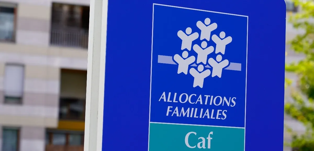 Exterior view of the CAF (Caisse d'Allocations Familiales) office in France, featuring the entrance and signage. The office provides assistance and support for families and students seeking financial aid.